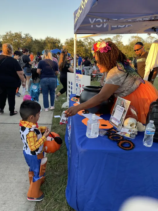 Handing out treats at the fall festival